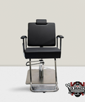 A black, adjustable salon chair with a chrome frame and a headrest, positioned against a plain background.