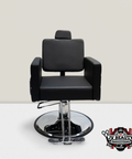 A black salon chair with quilted embroidery on the back and arms, equipped with a hydraulic pump and a round mirror.